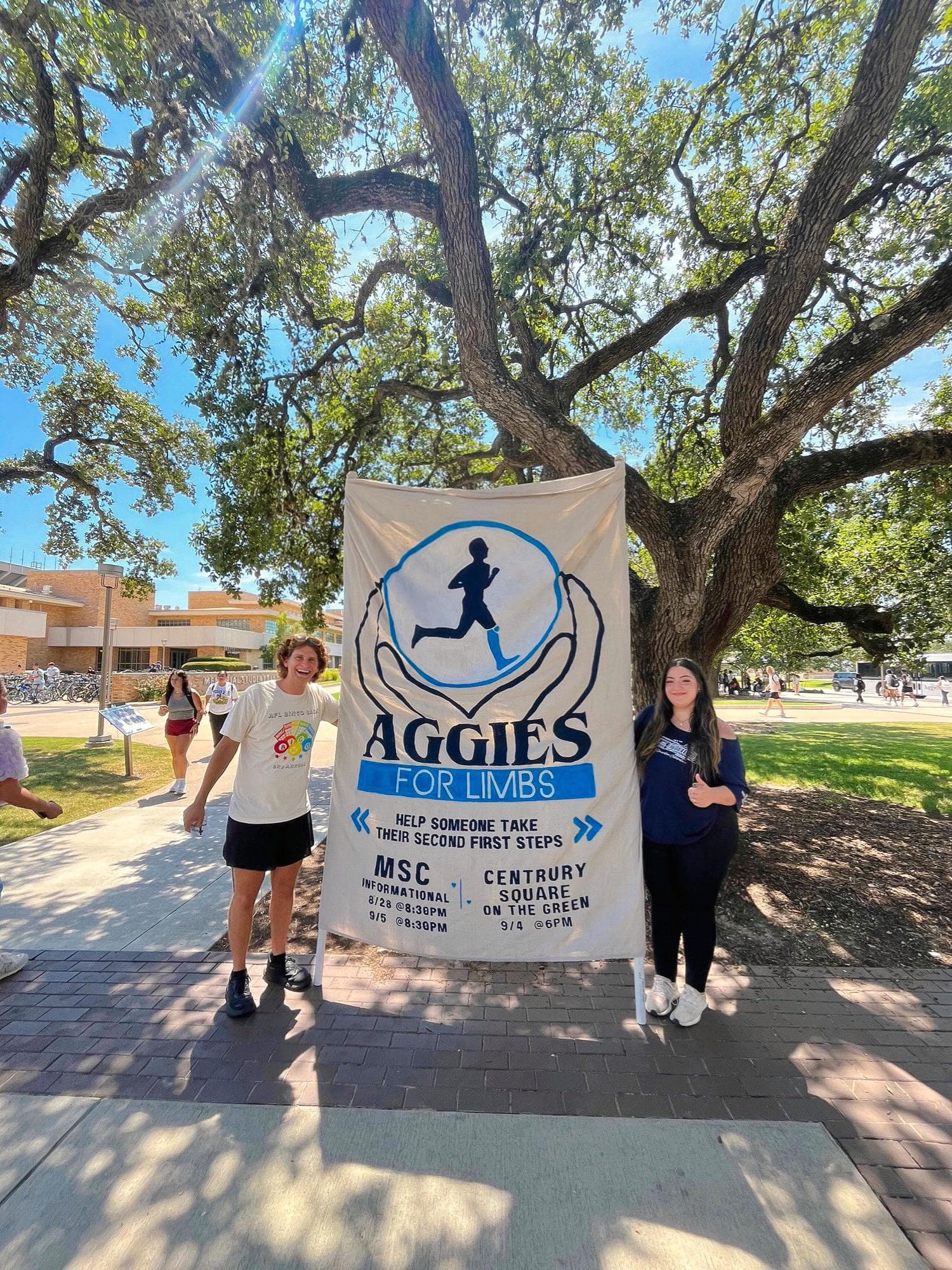 Advertising Committee in action - AFL members displaying recruitment banner featuring the organization's logo and upcoming informational meeting details