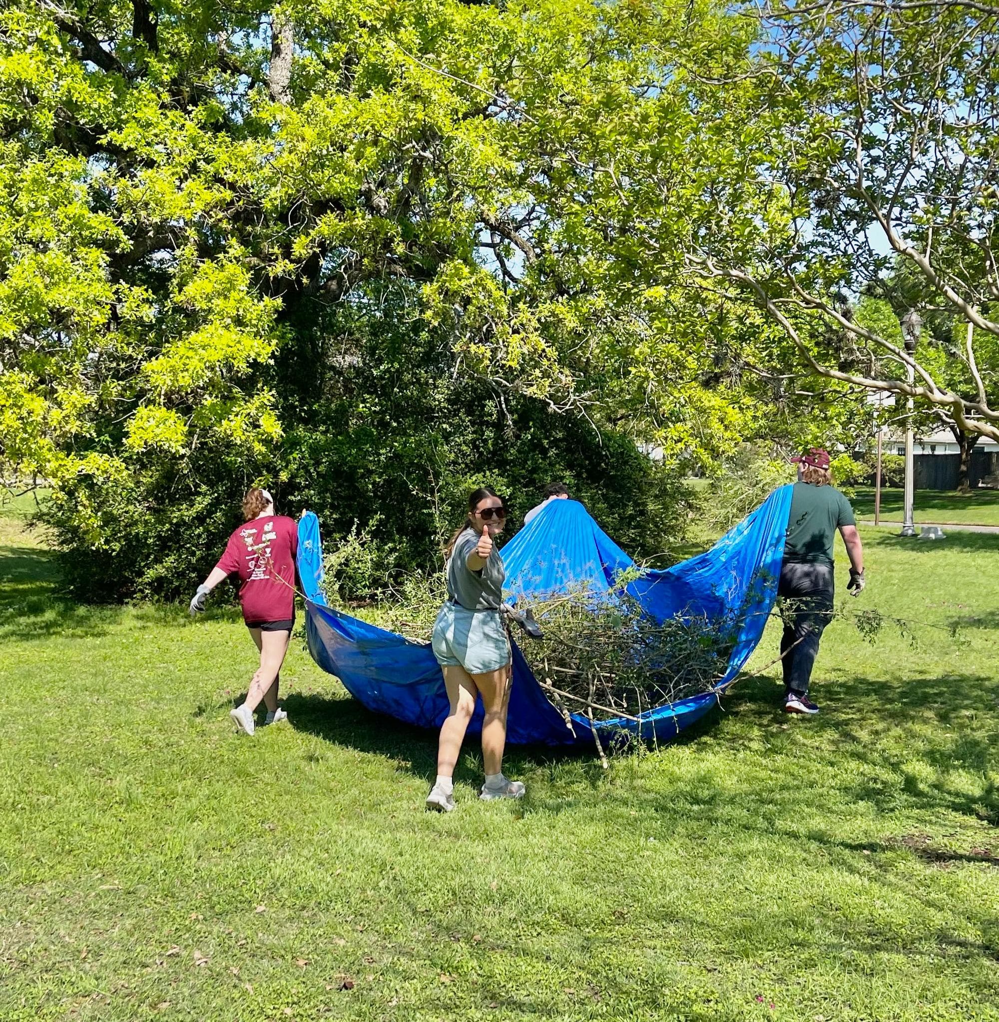 Service Committee in action - Members participating in an outdoor service project carrying supplies