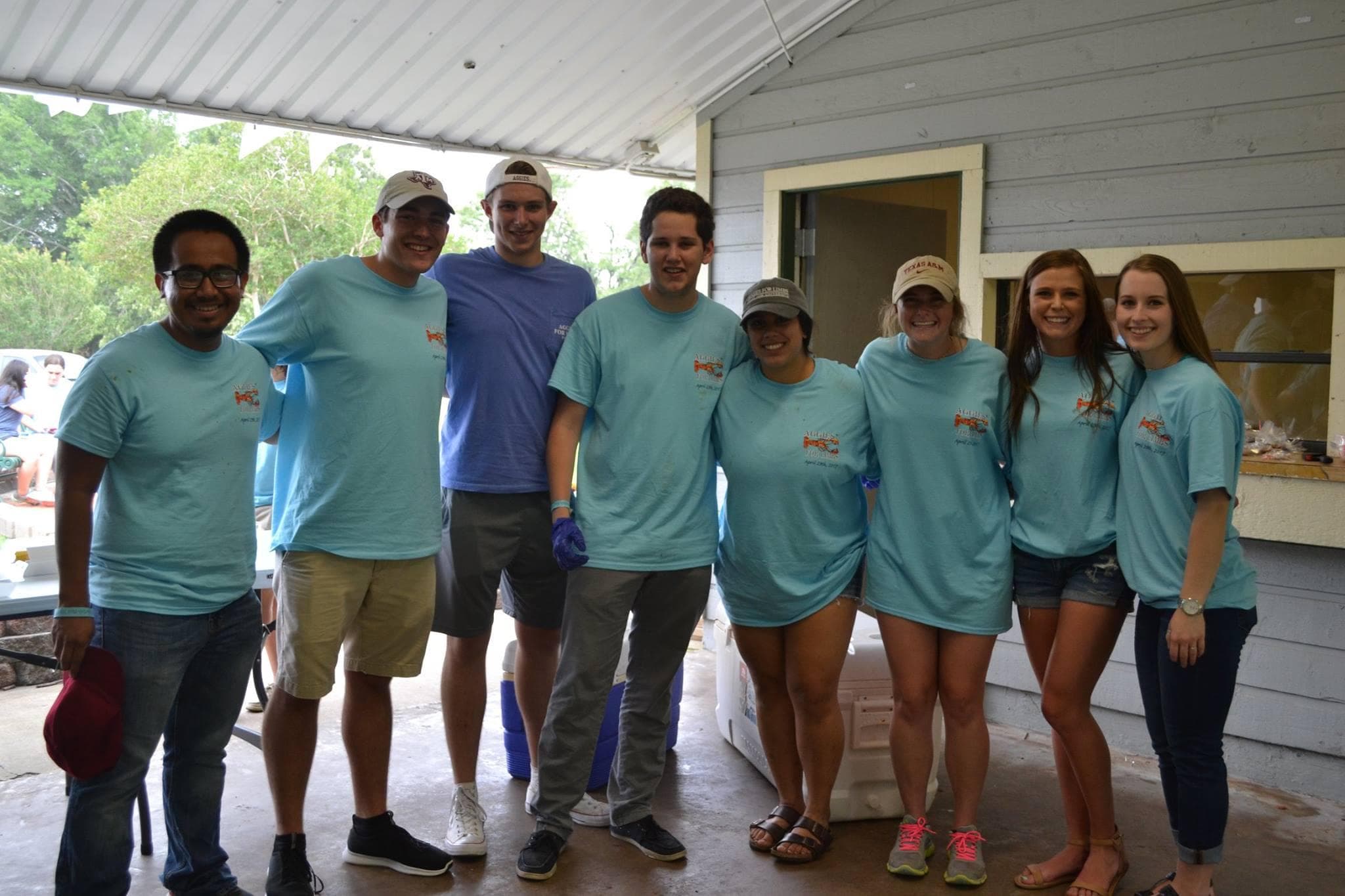 Group of AFL volunteers in matching light blue event shirts